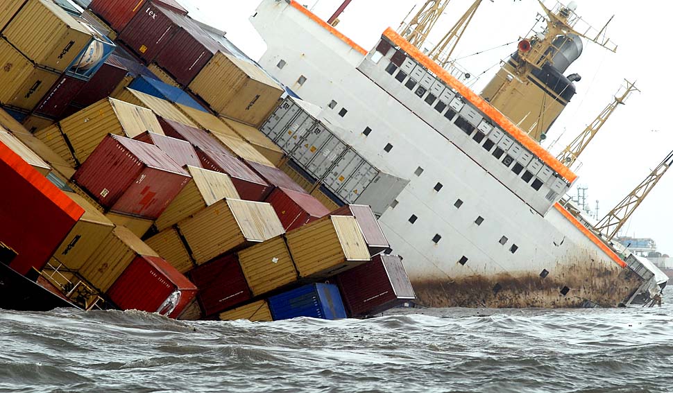 epa02279704 Containers are lose aboard the tilted cargo ship MSC Chitra after a collision with another similar vessel off the Mumbai coast, India, 09 August, 2010. At least 33 sailors on board were safely evacuated following the accident, Indian Coast Guard officials said. The ships, at least 200 meters in length, hit each other some five nautical miles off the coast of Mumbai, the report said. Due to the impact of the collision, MSC Chitra has dangerously tilted in the sea and rescue groups were seeing containers that it was carrying falling from it at regular intervals. The affected ship was loaded with an estimated 2,500 tonnes of oil at the time of the accident, but officials declined to comment on the information.  EPA/DIVYAKANT SOLANKI
